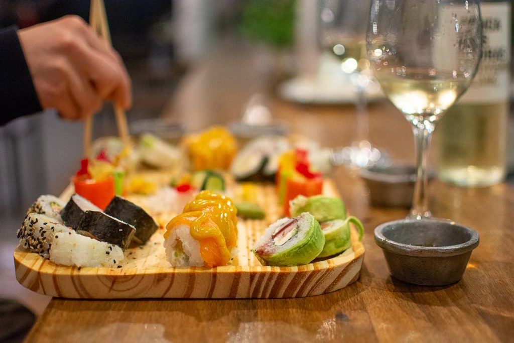 pexels-photo-12026747 Vibrant sushi platter with wine pairing for an elegant dining experience.