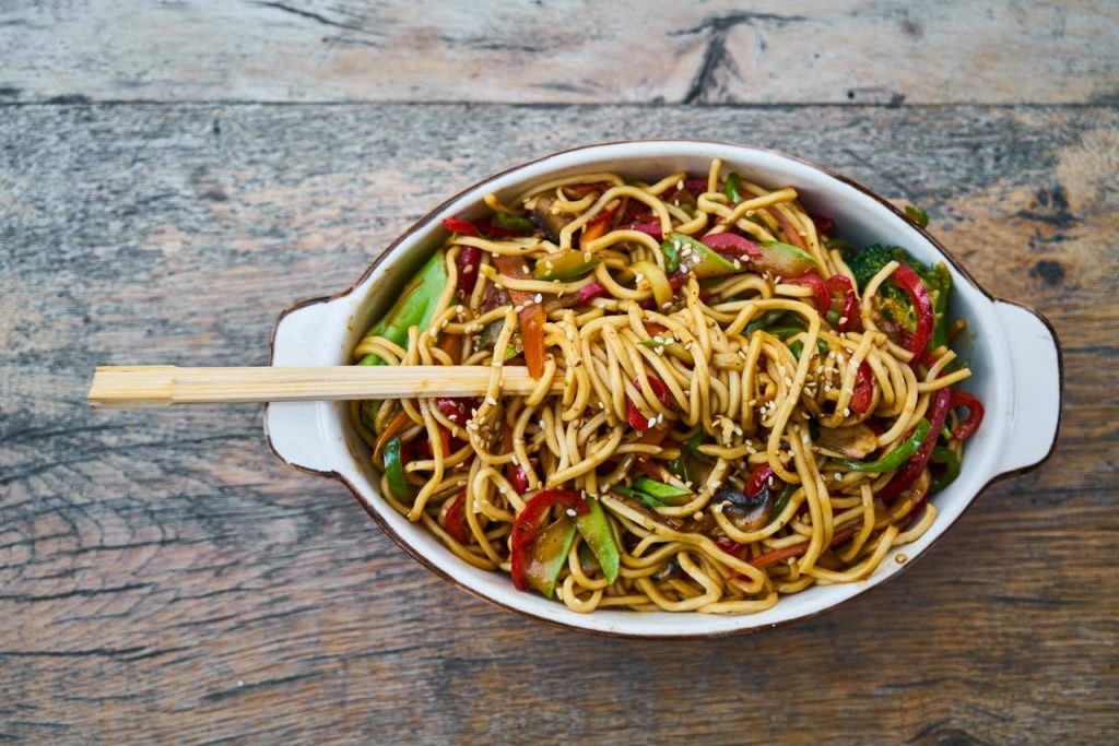 pexels-photo-2347311 Tasty stir-fried noodles with fresh vegetables and sesame seeds, perfect for a healthy meal.